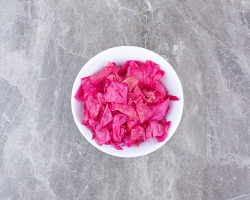 Pickled red cabbage in white bowl. High quality photo